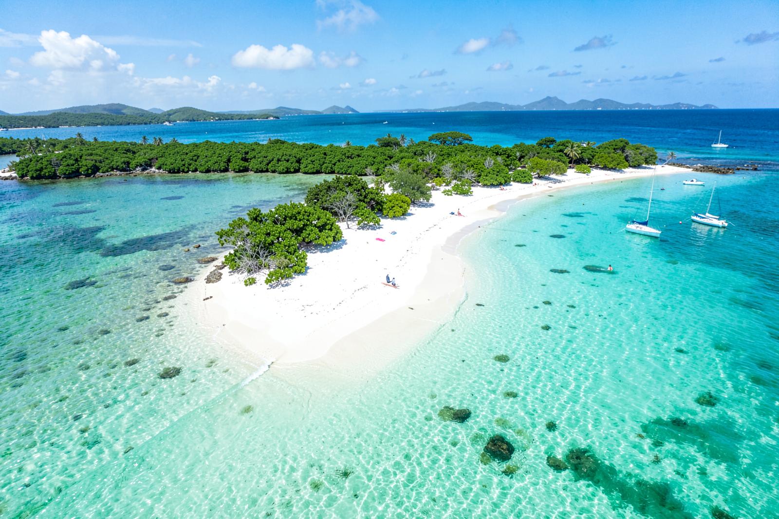 Aerial view of a white sand beach and turquoise water in Antigua